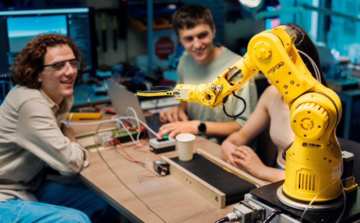 Group of young people doing experiments in robotics in a laboratory